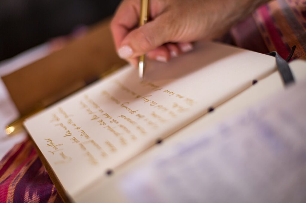 Close up of hand writing in a book